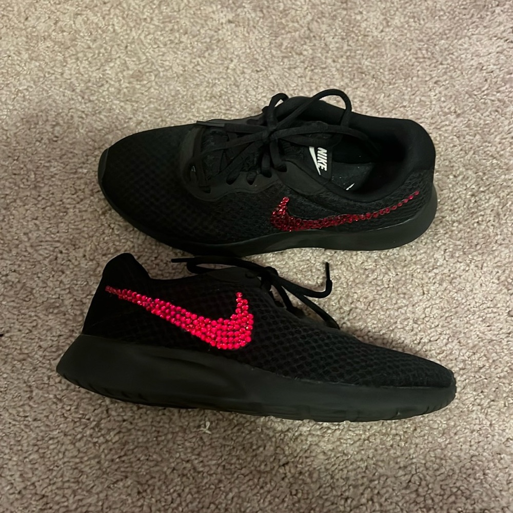 Black Nike sneakers with red rhinestoned swoosh